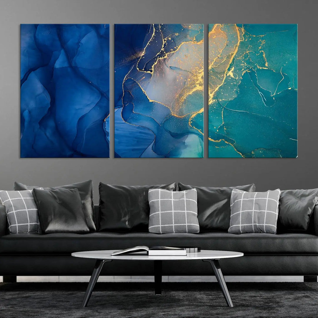 A Navy Blue and Green Marble Fluid Effect Wall Art Abstract Canvas Wall Art Print, featuring captivating patterns of blue and teal hues interlaced with gold veining, is ready to hang and protected by a UV-coating to preserve its vibrant colors over time.