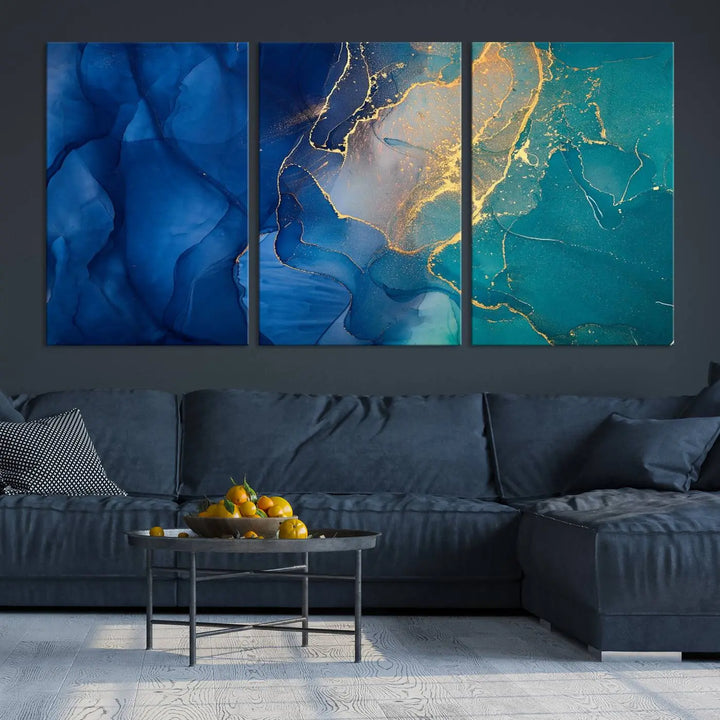 A Navy Blue and Green Marble Fluid Effect Wall Art Abstract Canvas Wall Art Print, featuring captivating patterns of blue and teal hues interlaced with gold veining, is ready to hang and protected by a UV-coating to preserve its vibrant colors over time.