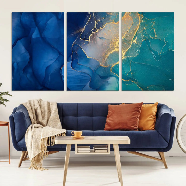 A Navy Blue and Green Marble Fluid Effect Wall Art Abstract Canvas Wall Art Print, featuring captivating patterns of blue and teal hues interlaced with gold veining, is ready to hang and protected by a UV-coating to preserve its vibrant colors over time.