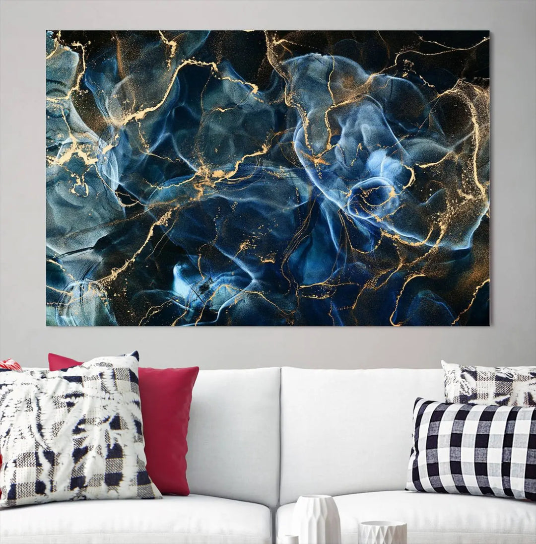 The Navy Blue and Smokey Marble Fluid Effect Abstract Canvas Wall Art Print features a swirling blue and gold pattern in a gallery-wrapped, museum-quality design.