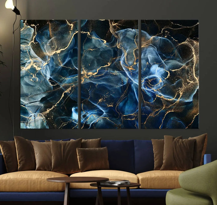 The Navy Blue and Smokey Marble Fluid Effect Abstract Canvas Wall Art Print features a swirling blue and gold pattern in a gallery-wrapped, museum-quality design.