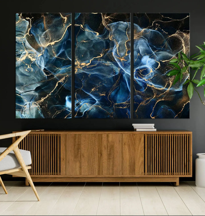 The Navy Blue and Smokey Marble Fluid Effect Abstract Canvas Wall Art Print features a swirling blue and gold pattern in a gallery-wrapped, museum-quality design.