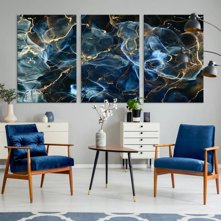 The Navy Blue and Smokey Marble Fluid Effect Abstract Canvas Wall Art Print features a swirling blue and gold pattern in a gallery-wrapped, museum-quality design.