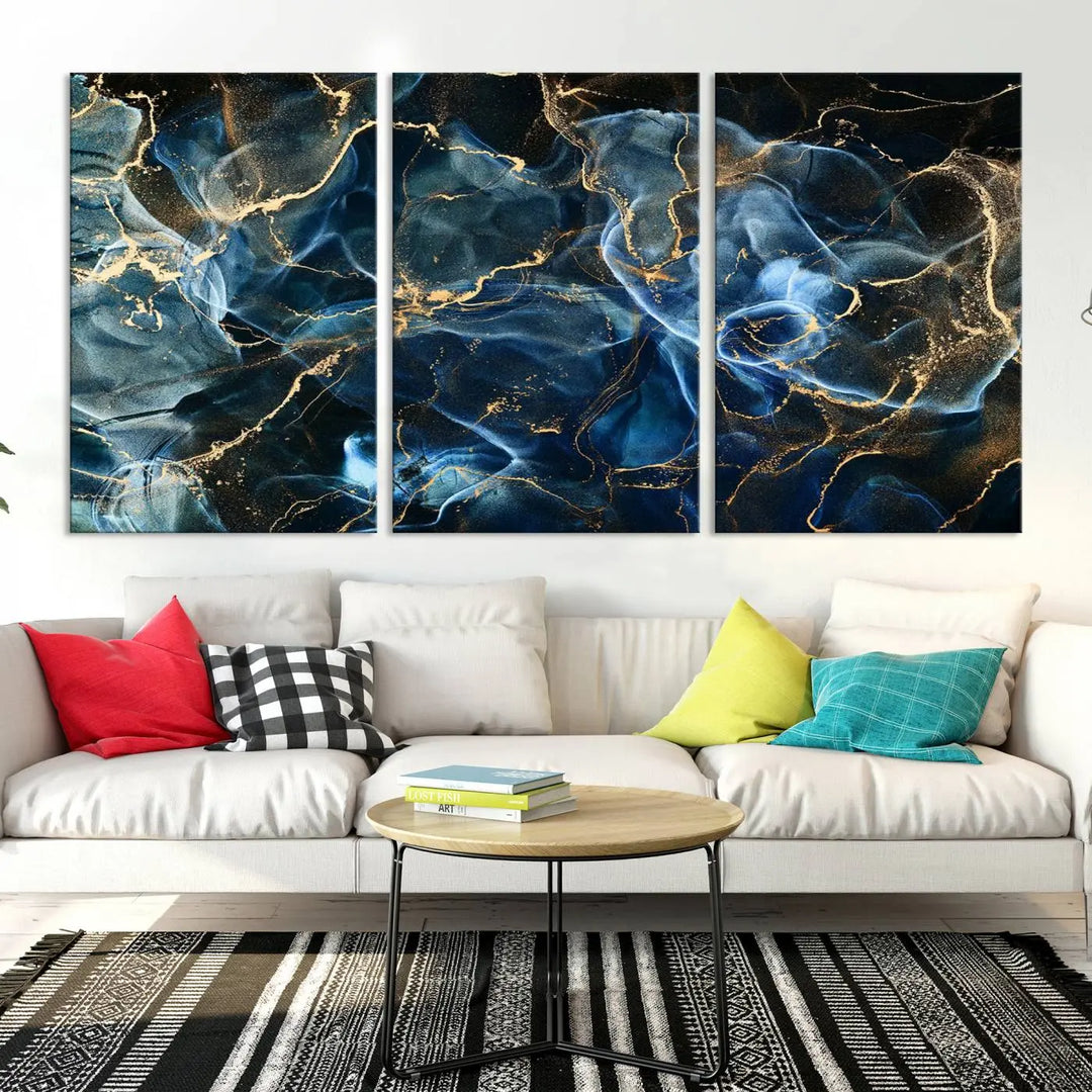 The Navy Blue and Smokey Marble Fluid Effect Abstract Canvas Wall Art Print features a swirling blue and gold pattern in a gallery-wrapped, museum-quality design.