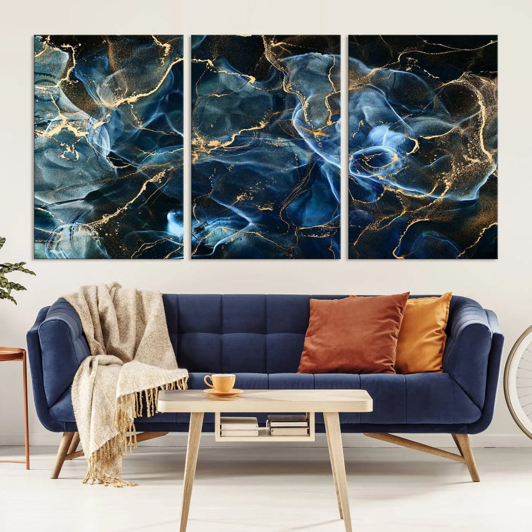 The Navy Blue and Smokey Marble Fluid Effect Abstract Canvas Wall Art Print features a swirling blue and gold pattern in a gallery-wrapped, museum-quality design.