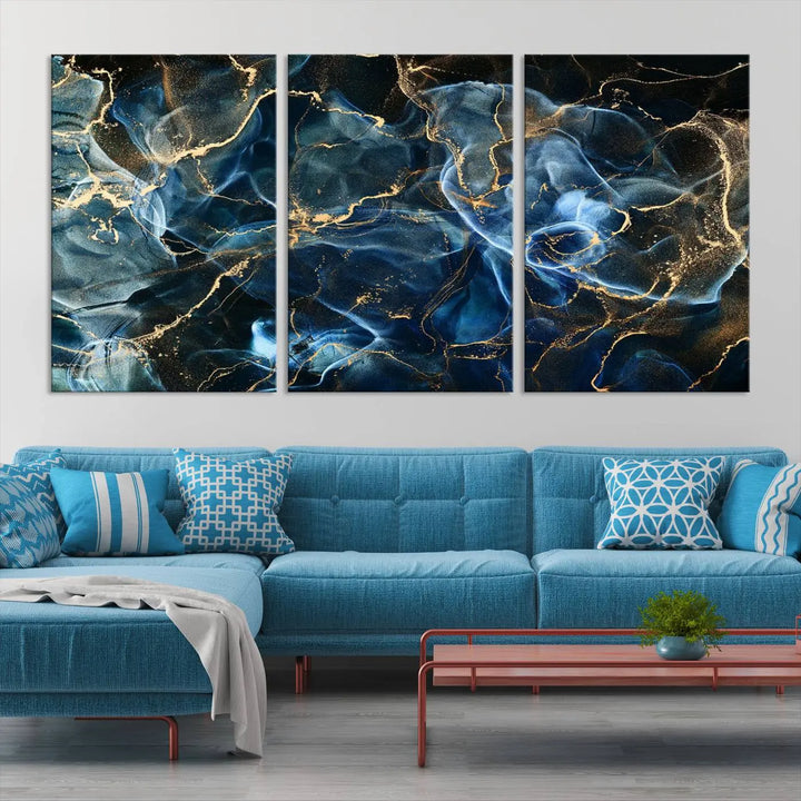 The Navy Blue and Smokey Marble Fluid Effect Abstract Canvas Wall Art Print features a swirling blue and gold pattern in a gallery-wrapped, museum-quality design.