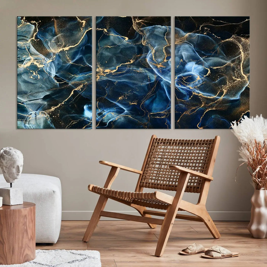 The Navy Blue and Smokey Marble Fluid Effect Abstract Canvas Wall Art Print features a swirling blue and gold pattern in a gallery-wrapped, museum-quality design.