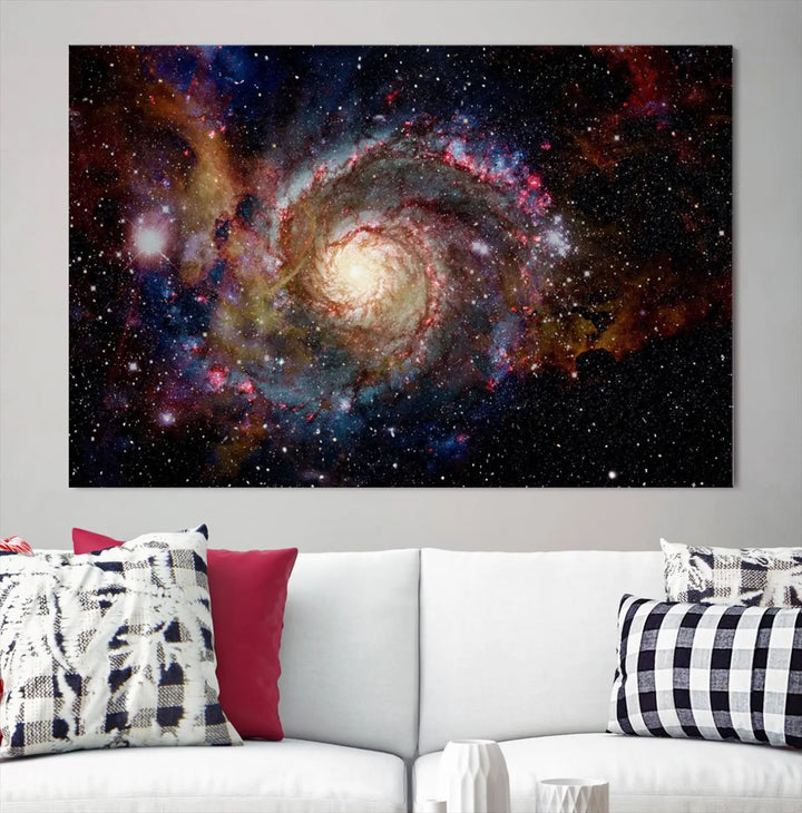 The modern living room is adorned with the Nebula and Galaxies in Space Wall Art, a spiral galaxy canvas print that showcases high-resolution details on museum-quality canvas. The UV-protective coating ensures its stunning allure is preserved.