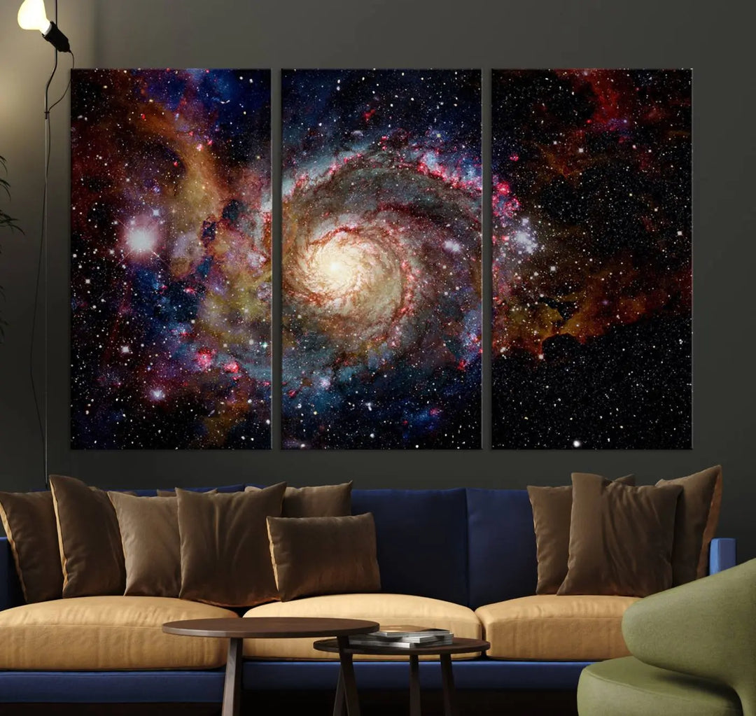 The modern living room is adorned with the Nebula and Galaxies in Space Wall Art, a spiral galaxy canvas print that showcases high-resolution details on museum-quality canvas. The UV-protective coating ensures its stunning allure is preserved.