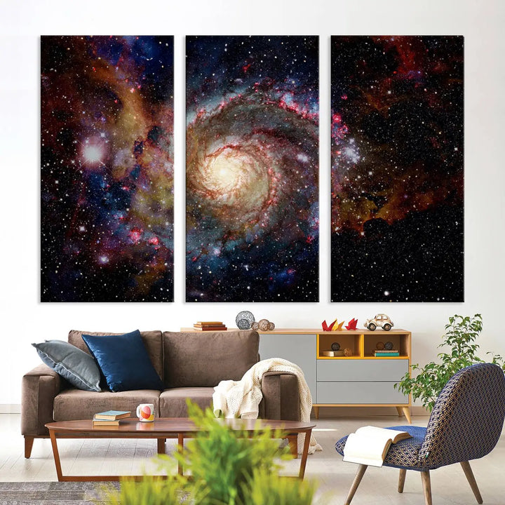 The modern living room is adorned with the Nebula and Galaxies in Space Wall Art, a spiral galaxy canvas print that showcases high-resolution details on museum-quality canvas. The UV-protective coating ensures its stunning allure is preserved.