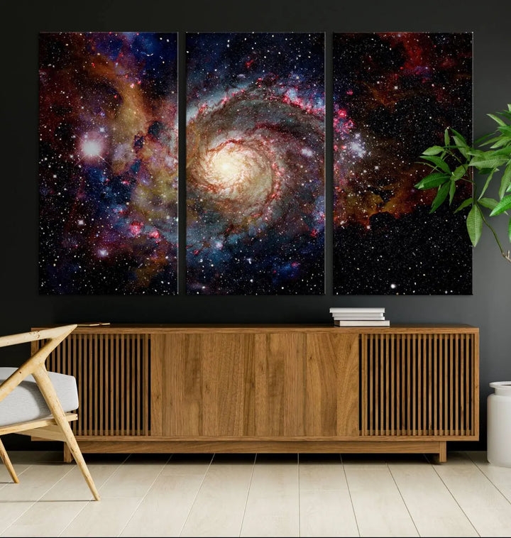 The modern living room is adorned with the Nebula and Galaxies in Space Wall Art, a spiral galaxy canvas print that showcases high-resolution details on museum-quality canvas. The UV-protective coating ensures its stunning allure is preserved.