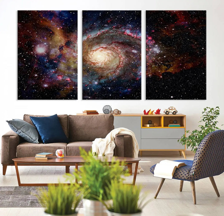 The modern living room is adorned with the Nebula and Galaxies in Space Wall Art, a spiral galaxy canvas print that showcases high-resolution details on museum-quality canvas. The UV-protective coating ensures its stunning allure is preserved.