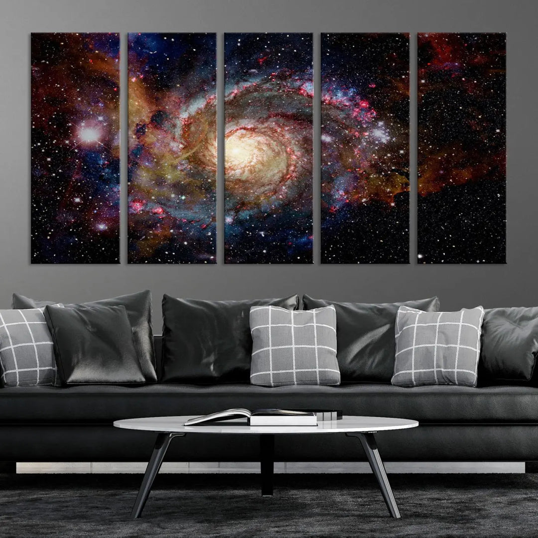 The modern living room is adorned with the Nebula and Galaxies in Space Wall Art, a spiral galaxy canvas print that showcases high-resolution details on museum-quality canvas. The UV-protective coating ensures its stunning allure is preserved.