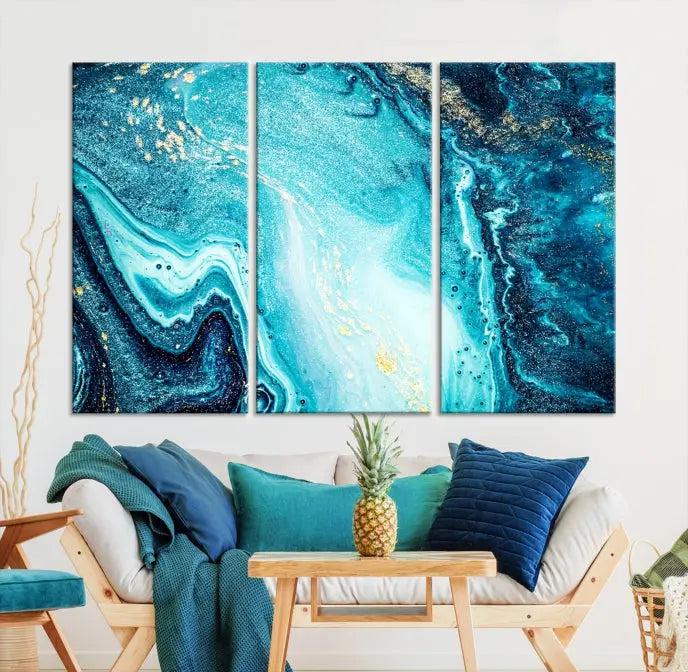 The Neon Blue and Gold Marble Fluid Effect Wall Art Abstract Canvas Wall Art Print graces the wall, displayed on museum-quality canvas.