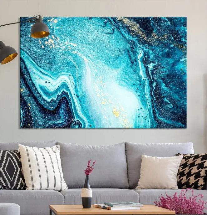 The Neon Blue and Gold Marble Fluid Effect Wall Art Abstract Canvas Wall Art Print graces the wall, displayed on museum-quality canvas.