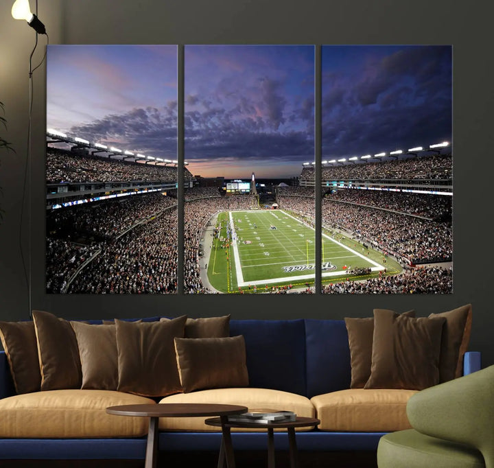 The living room showcases a remarkable set of canvases, the "New England Patriots Football Team Print - Foxborough Gillette Stadium Wall Art Canvas Print." This triptych captures a crowded football stadium at sunset, and each piece is coated with UV-protective layers to ensure lasting vibrancy. Additionally, you can enjoy the benefit of free shipping with your purchase.