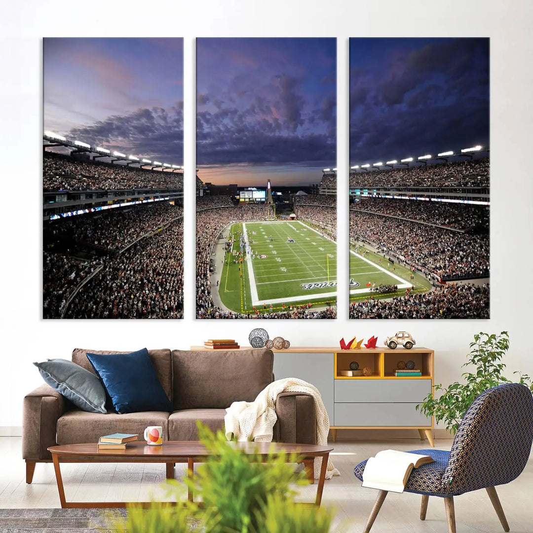 The living room showcases a remarkable set of canvases, the "New England Patriots Football Team Print - Foxborough Gillette Stadium Wall Art Canvas Print." This triptych captures a crowded football stadium at sunset, and each piece is coated with UV-protective layers to ensure lasting vibrancy. Additionally, you can enjoy the benefit of free shipping with your purchase.