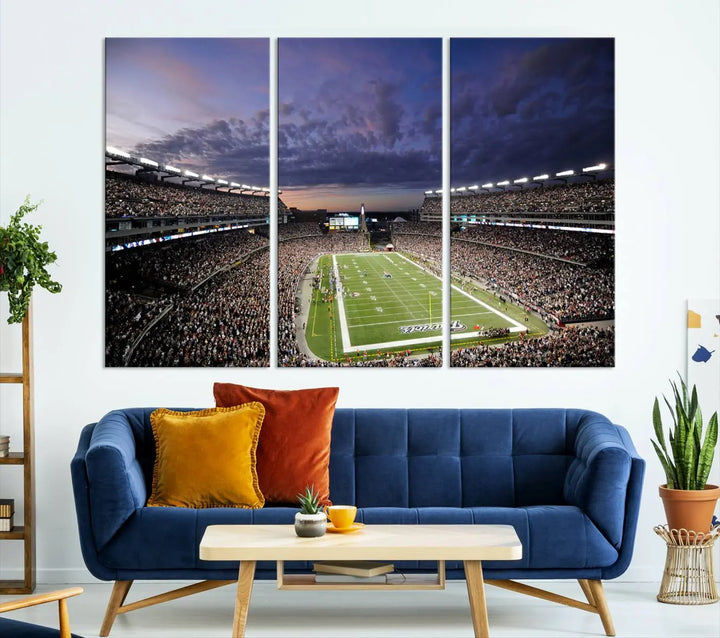 The living room showcases a remarkable set of canvases, the "New England Patriots Football Team Print - Foxborough Gillette Stadium Wall Art Canvas Print." This triptych captures a crowded football stadium at sunset, and each piece is coated with UV-protective layers to ensure lasting vibrancy. Additionally, you can enjoy the benefit of free shipping with your purchase.