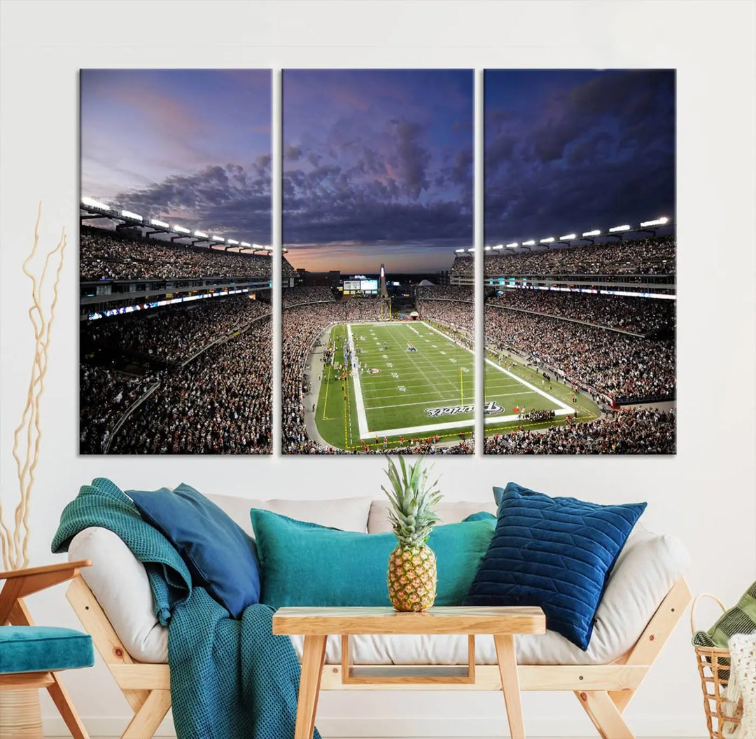 The living room showcases a remarkable set of canvases, the "New England Patriots Football Team Print - Foxborough Gillette Stadium Wall Art Canvas Print." This triptych captures a crowded football stadium at sunset, and each piece is coated with UV-protective layers to ensure lasting vibrancy. Additionally, you can enjoy the benefit of free shipping with your purchase.