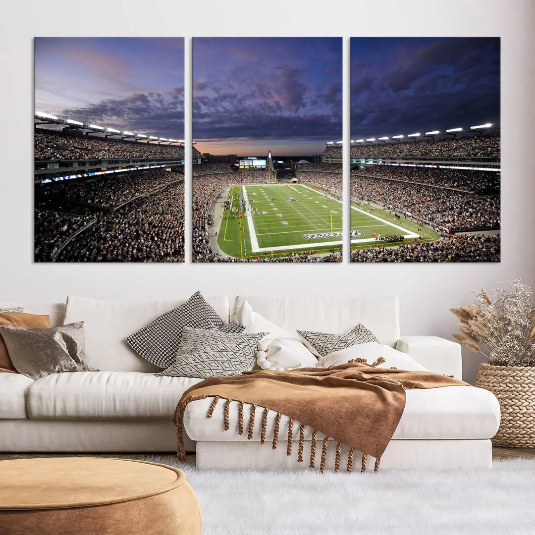 The living room showcases a remarkable set of canvases, the "New England Patriots Football Team Print - Foxborough Gillette Stadium Wall Art Canvas Print." This triptych captures a crowded football stadium at sunset, and each piece is coated with UV-protective layers to ensure lasting vibrancy. Additionally, you can enjoy the benefit of free shipping with your purchase.