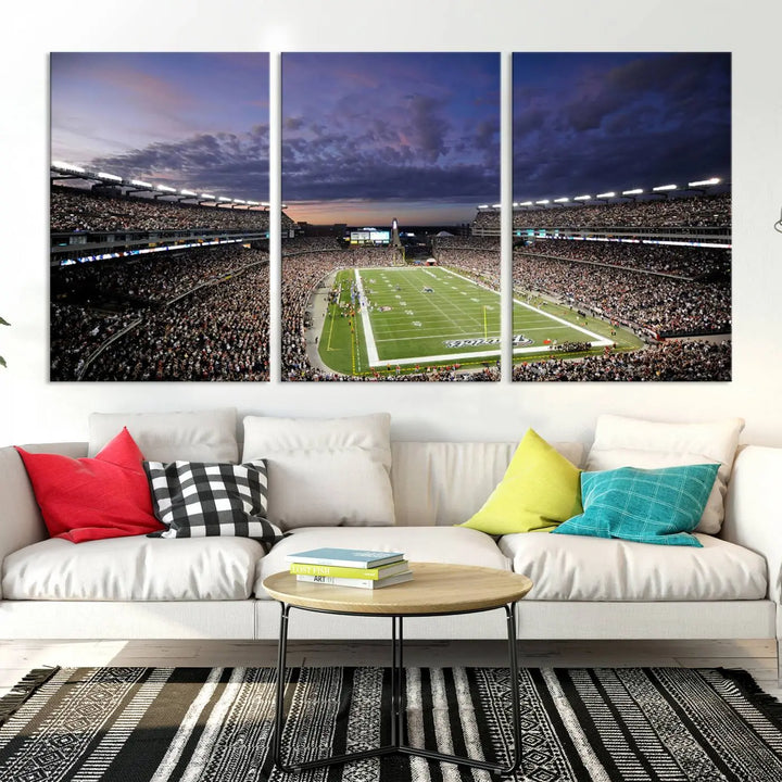 The living room showcases a remarkable set of canvases, the "New England Patriots Football Team Print - Foxborough Gillette Stadium Wall Art Canvas Print." This triptych captures a crowded football stadium at sunset, and each piece is coated with UV-protective layers to ensure lasting vibrancy. Additionally, you can enjoy the benefit of free shipping with your purchase.