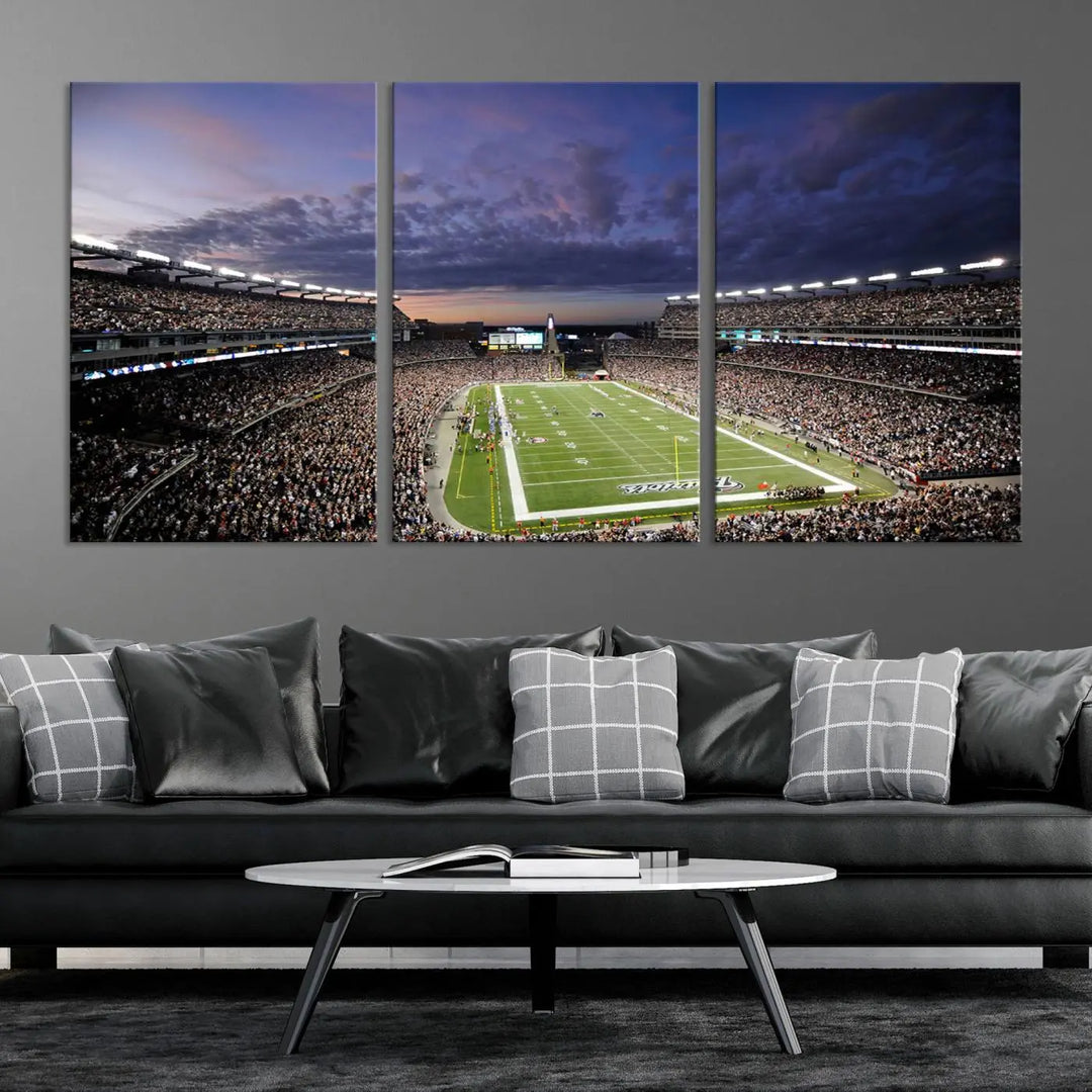 The living room showcases a remarkable set of canvases, the "New England Patriots Football Team Print - Foxborough Gillette Stadium Wall Art Canvas Print." This triptych captures a crowded football stadium at sunset, and each piece is coated with UV-protective layers to ensure lasting vibrancy. Additionally, you can enjoy the benefit of free shipping with your purchase.