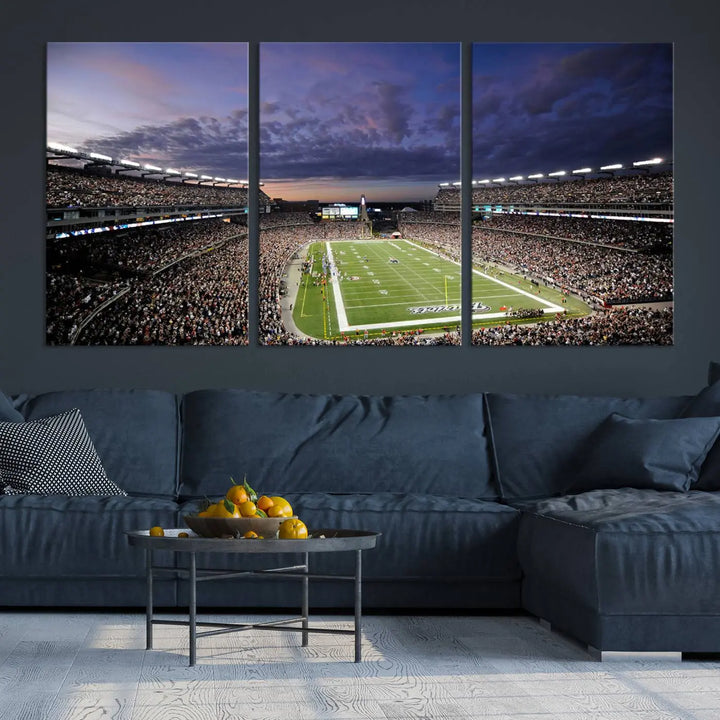 The living room showcases a remarkable set of canvases, the "New England Patriots Football Team Print - Foxborough Gillette Stadium Wall Art Canvas Print." This triptych captures a crowded football stadium at sunset, and each piece is coated with UV-protective layers to ensure lasting vibrancy. Additionally, you can enjoy the benefit of free shipping with your purchase.