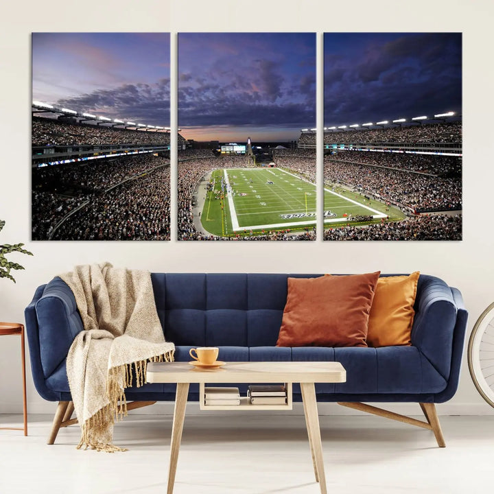 The living room showcases a remarkable set of canvases, the "New England Patriots Football Team Print - Foxborough Gillette Stadium Wall Art Canvas Print." This triptych captures a crowded football stadium at sunset, and each piece is coated with UV-protective layers to ensure lasting vibrancy. Additionally, you can enjoy the benefit of free shipping with your purchase.