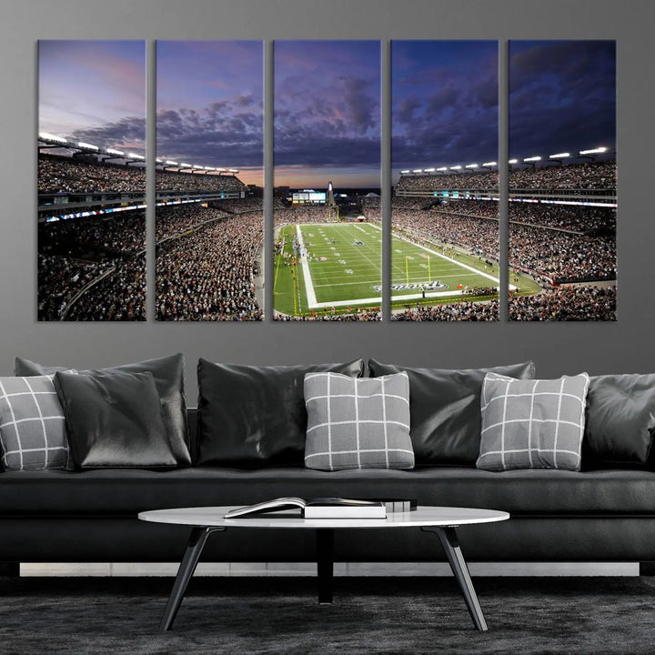 The living room showcases a remarkable set of canvases, the "New England Patriots Football Team Print - Foxborough Gillette Stadium Wall Art Canvas Print." This triptych captures a crowded football stadium at sunset, and each piece is coated with UV-protective layers to ensure lasting vibrancy. Additionally, you can enjoy the benefit of free shipping with your purchase.