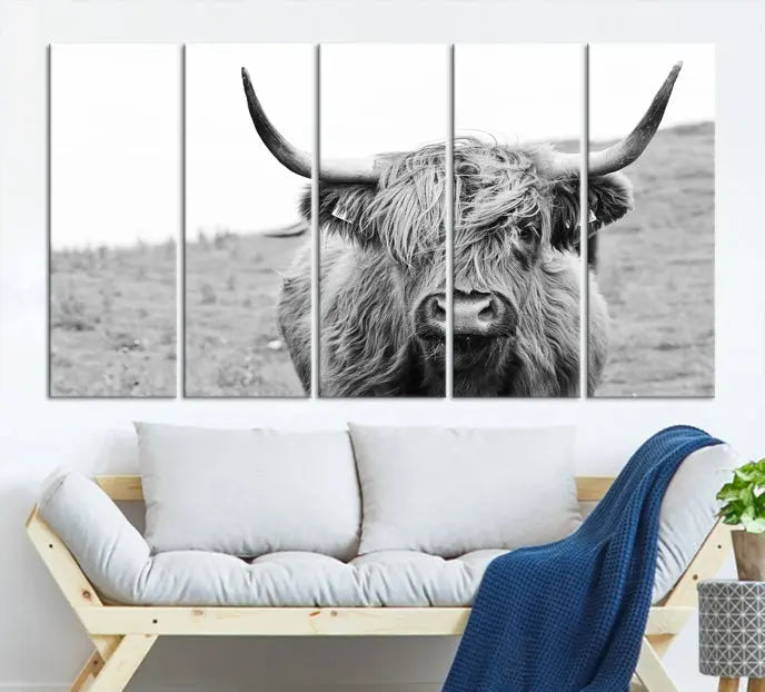 Newfoundland Cow Art Wall Art Canvas Print features a museum-quality, black-and-white triptych of a Highland cow with large horns, ideal for hanging on a dark wall.