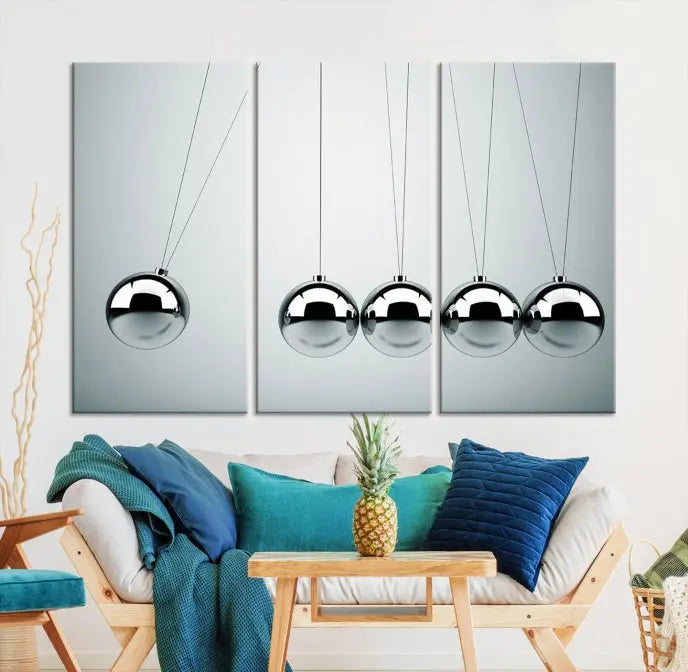 The contemporary living room features three Newton's Cradle Wall Art Canvas Prints on museum-quality polycotton canvas, each with gallery-wrapped edges for an enhanced finish.