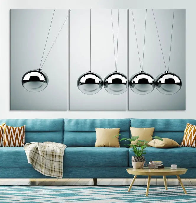 The contemporary living room features three Newton's Cradle Wall Art Canvas Prints on museum-quality polycotton canvas, each with gallery-wrapped edges for an enhanced finish.