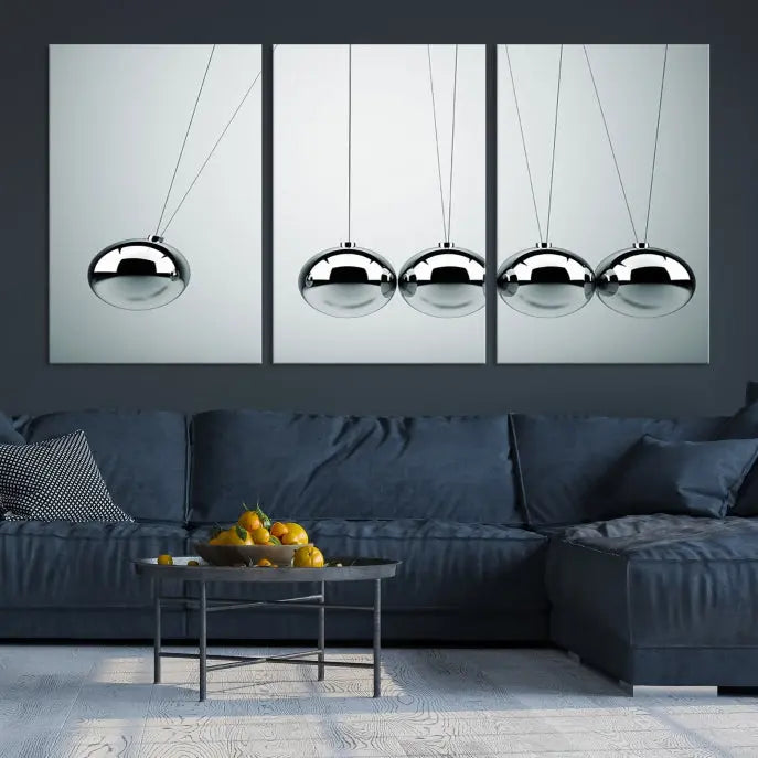 The contemporary living room features three Newton's Cradle Wall Art Canvas Prints on museum-quality polycotton canvas, each with gallery-wrapped edges for an enhanced finish.