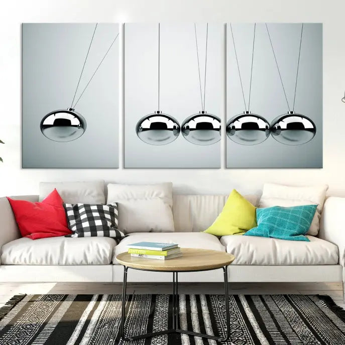 The contemporary living room features three Newton's Cradle Wall Art Canvas Prints on museum-quality polycotton canvas, each with gallery-wrapped edges for an enhanced finish.