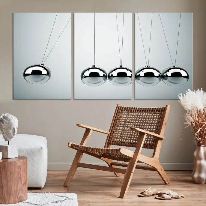 The contemporary living room features three Newton's Cradle Wall Art Canvas Prints on museum-quality polycotton canvas, each with gallery-wrapped edges for an enhanced finish.