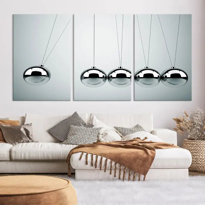 The contemporary living room features three Newton's Cradle Wall Art Canvas Prints on museum-quality polycotton canvas, each with gallery-wrapped edges for an enhanced finish.