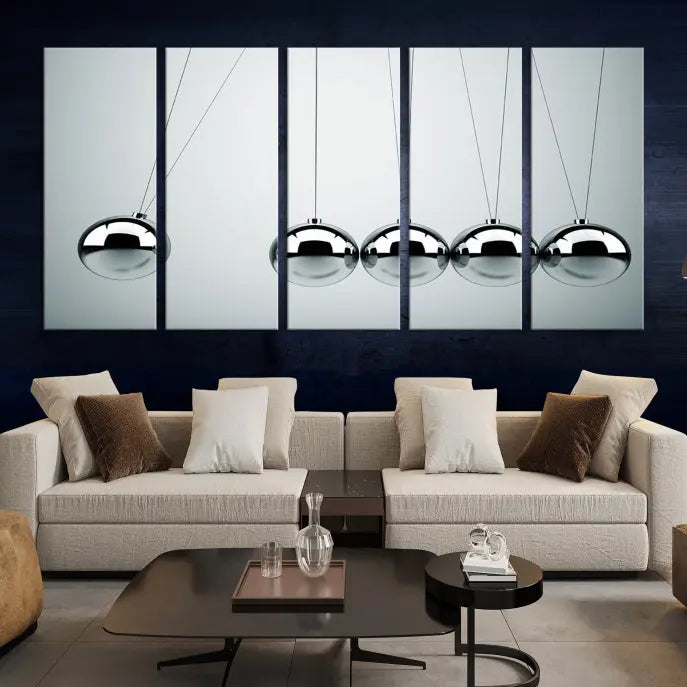 The contemporary living room features three Newton's Cradle Wall Art Canvas Prints on museum-quality polycotton canvas, each with gallery-wrapped edges for an enhanced finish.