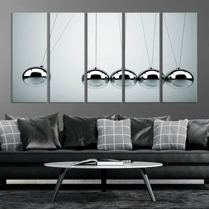 The contemporary living room features three Newton's Cradle Wall Art Canvas Prints on museum-quality polycotton canvas, each with gallery-wrapped edges for an enhanced finish.