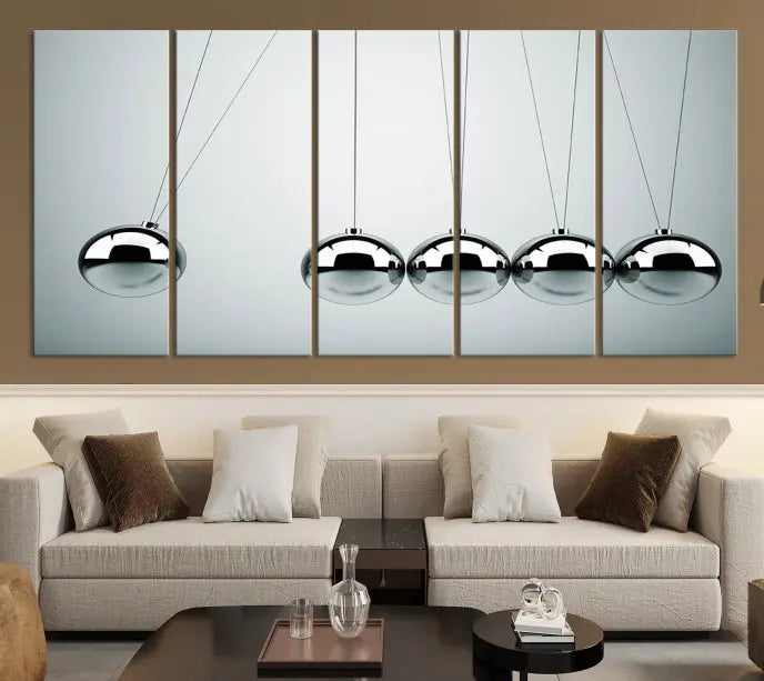 The contemporary living room features three Newton's Cradle Wall Art Canvas Prints on museum-quality polycotton canvas, each with gallery-wrapped edges for an enhanced finish.