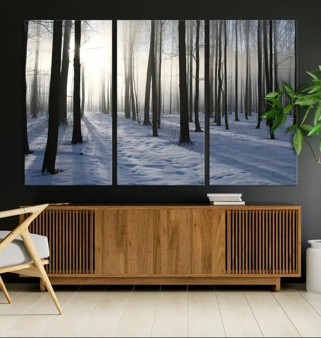 The "Night Forest Wall Art" canvas print showcases a snowy forest bathed in soft sunlight. It is printed on museum-quality canvas with a UV-protective coating.