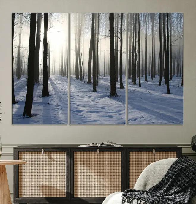 The "Night Forest Wall Art" canvas print showcases a snowy forest bathed in soft sunlight. It is printed on museum-quality canvas with a UV-protective coating.