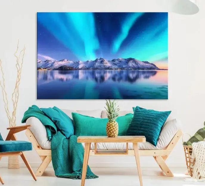 The room features the "Northern Lights above Mountain Wall Art Canvas Print," showcasing a triptych of the aurora borealis over snowy mountains and a lake. Professionally crafted frames on museum-quality canvases are highlighted in the modern decor.