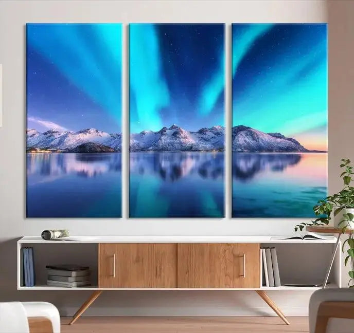 The room features the "Northern Lights above Mountain Wall Art Canvas Print," showcasing a triptych of the aurora borealis over snowy mountains and a lake. Professionally crafted frames on museum-quality canvases are highlighted in the modern decor.