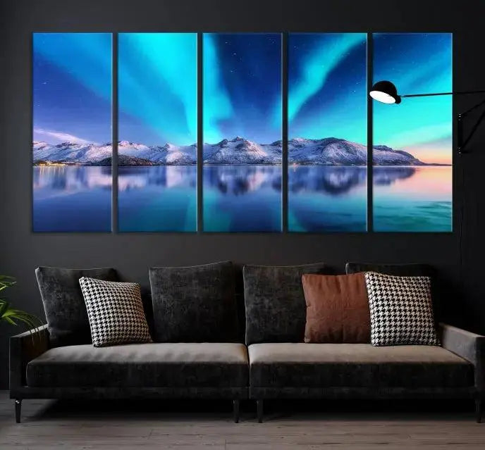 The room features the "Northern Lights above Mountain Wall Art Canvas Print," showcasing a triptych of the aurora borealis over snowy mountains and a lake. Professionally crafted frames on museum-quality canvases are highlighted in the modern decor.