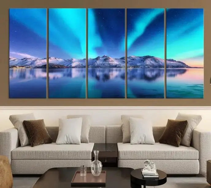 The room features the "Northern Lights above Mountain Wall Art Canvas Print," showcasing a triptych of the aurora borealis over snowy mountains and a lake. Professionally crafted frames on museum-quality canvases are highlighted in the modern decor.