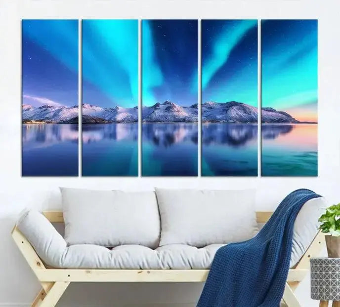 The room features the "Northern Lights above Mountain Wall Art Canvas Print," showcasing a triptych of the aurora borealis over snowy mountains and a lake. Professionally crafted frames on museum-quality canvases are highlighted in the modern decor.