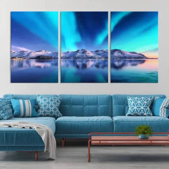 The room features the "Northern Lights above Mountain Wall Art Canvas Print," showcasing a triptych of the aurora borealis over snowy mountains and a lake. Professionally crafted frames on museum-quality canvases are highlighted in the modern decor.