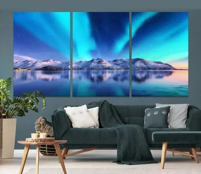 The room features the "Northern Lights above Mountain Wall Art Canvas Print," showcasing a triptych of the aurora borealis over snowy mountains and a lake. Professionally crafted frames on museum-quality canvases are highlighted in the modern decor.