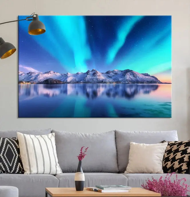 The room features the "Northern Lights above Mountain Wall Art Canvas Print," showcasing a triptych of the aurora borealis over snowy mountains and a lake. Professionally crafted frames on museum-quality canvases are highlighted in the modern decor.