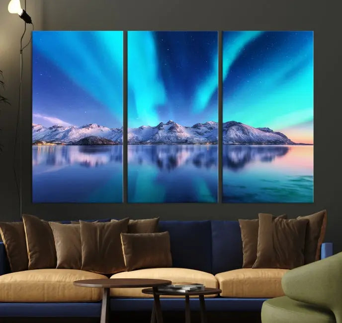 The room features the "Northern Lights above Mountain Wall Art Canvas Print," showcasing a triptych of the aurora borealis over snowy mountains and a lake. Professionally crafted frames on museum-quality canvases are highlighted in the modern decor.